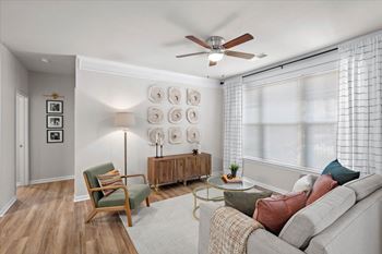 Lavish living room with oversized windows with blinds